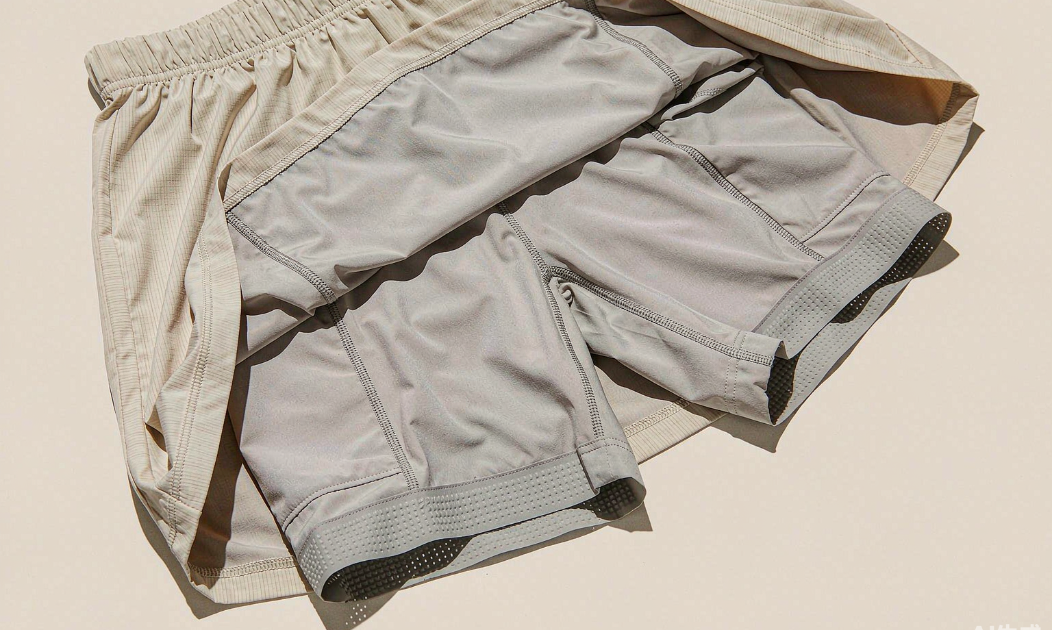 Flat lay of a tennis skort showing built-in compression inner shorts, elastic waistband, anti-slip gripper band and hidden ball pocket